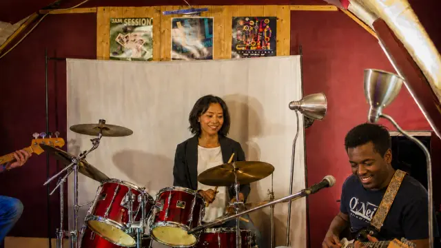Students playing together as a band in the studio